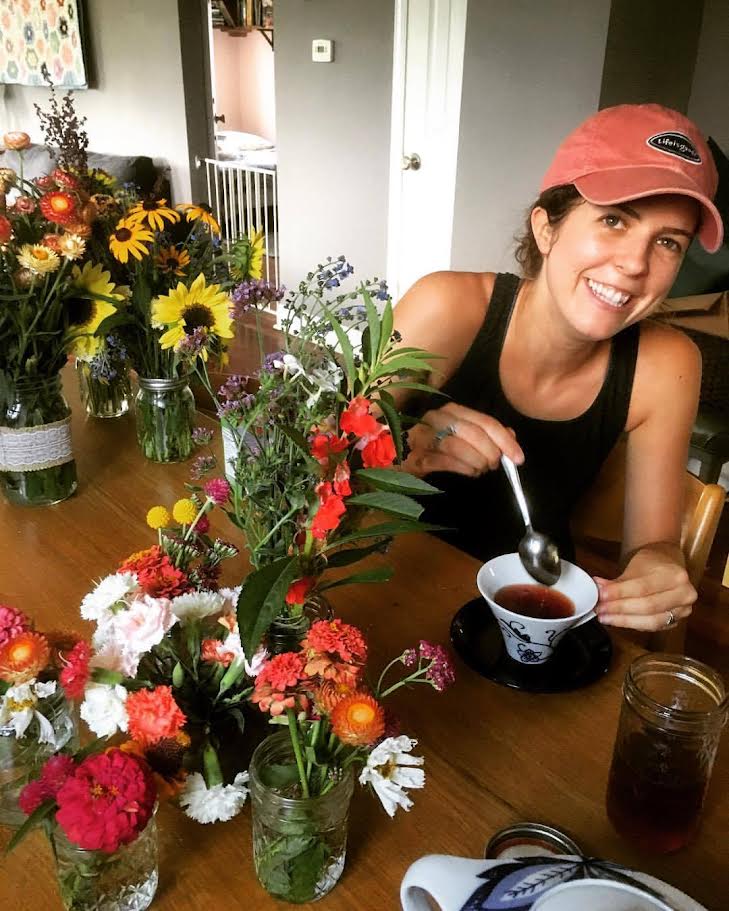 The author, Shannon, sitting at a table with tea
