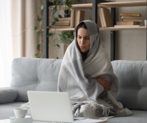 Woman bundled up completely in a blanket
