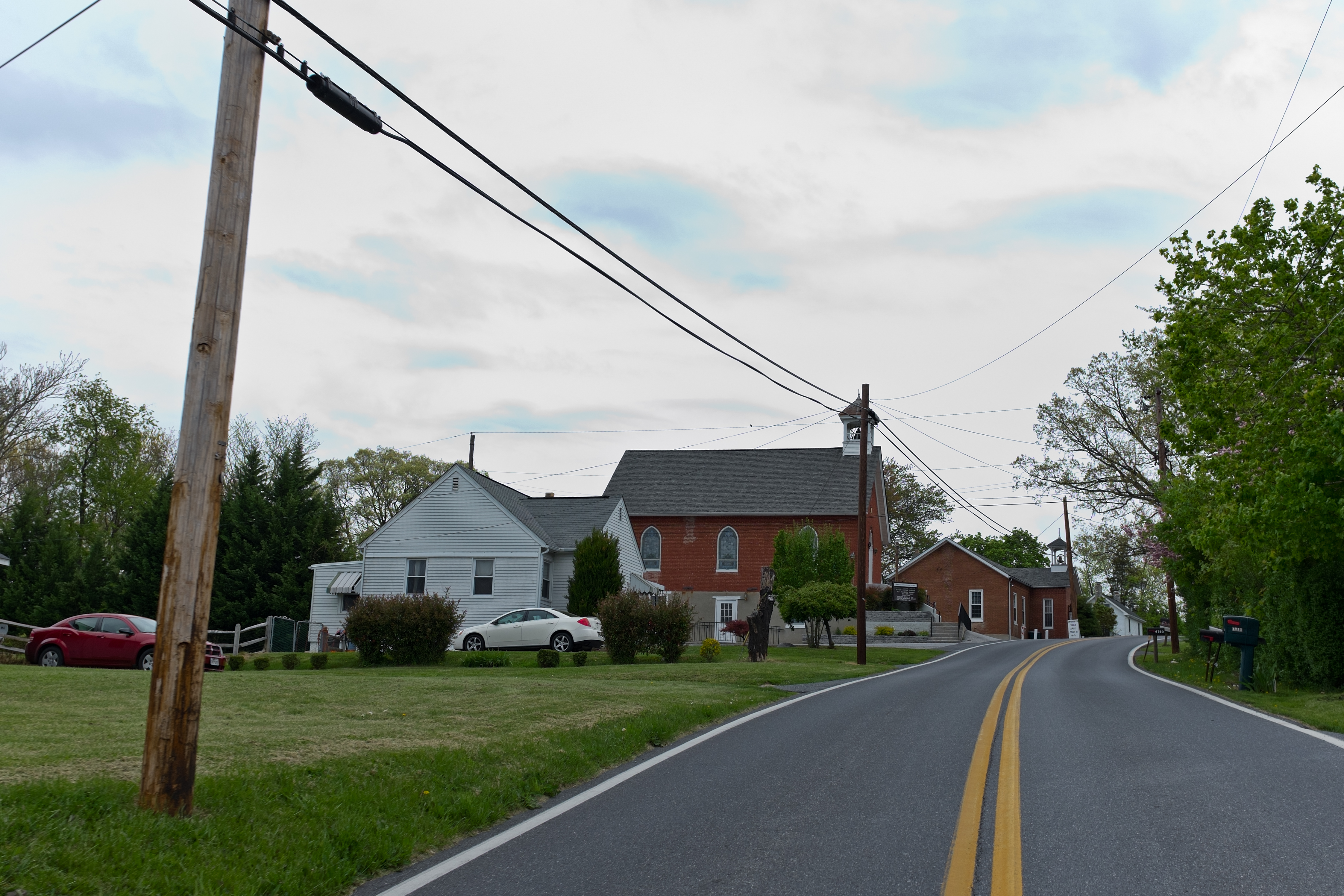 A road and church and other buildings in Ijamsville MD